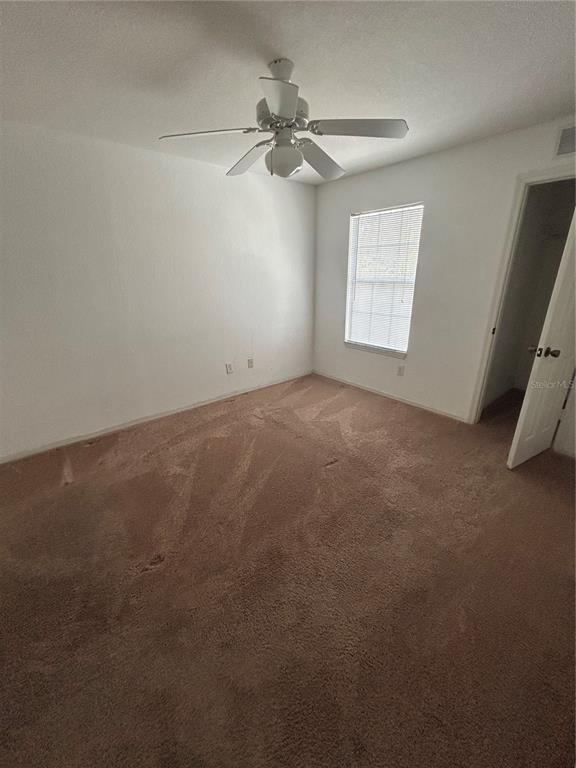 4850 51st Street West, Unit 8201 Bradenton, FL 34210 - Photo 8 of 14 an empty room with windows and fan
