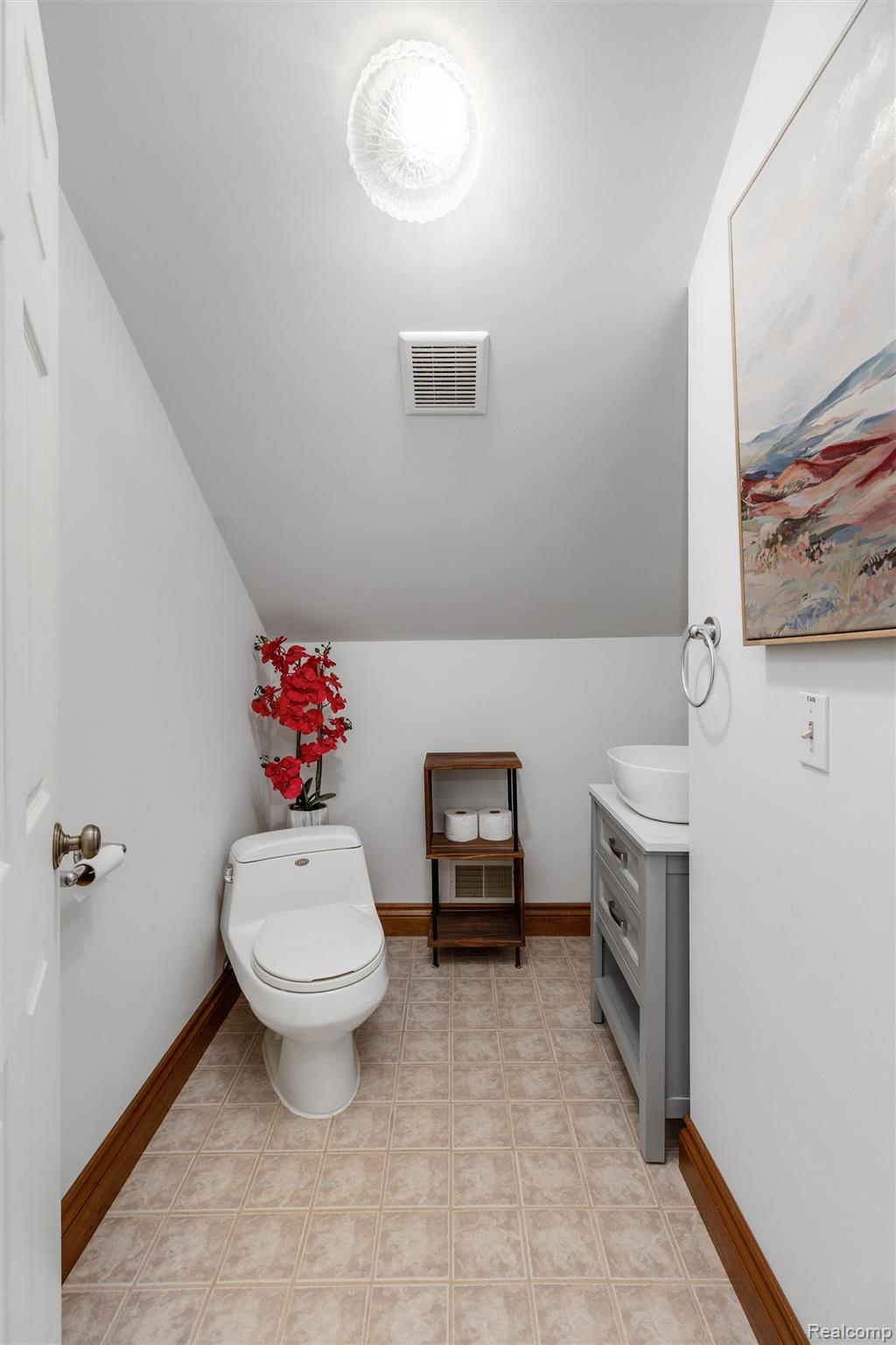 21280 Merriman Road New Boston, MI 48164 - Photo 53 of 65 Compact powder room featuring tiled flooring, a modern vanity with a vessel sink, a contemporary toilet, and a ceiling-mounted light fixture
