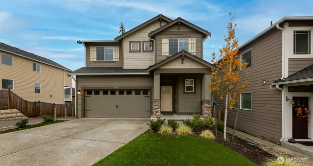 a front view of a house with a yard and garage