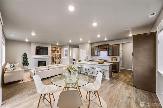 a large kitchen with a table and chairs