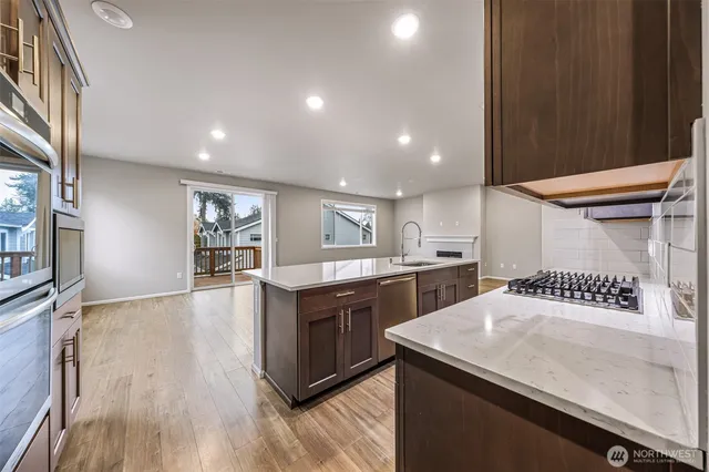 a kitchen with a sink a stove and cabinets