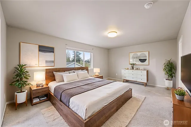 a bedroom with a bed and a couch