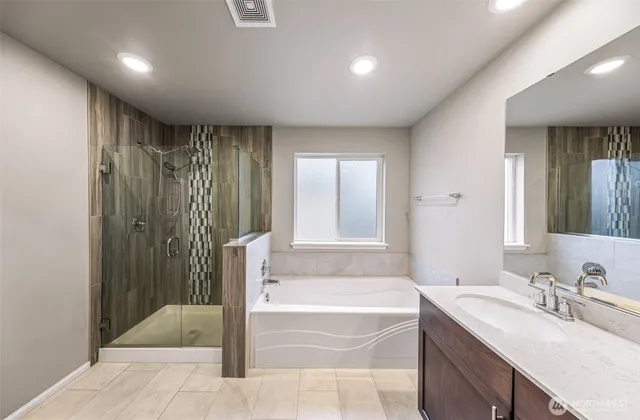 a bathroom with a bathtub and a sink