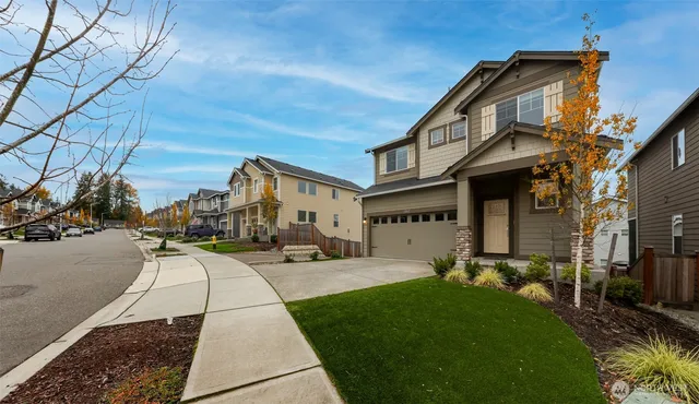a front view of a house with a yard
