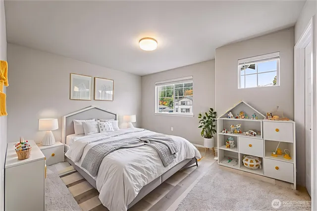 a bedroom with a bed and a dresser next to a window
