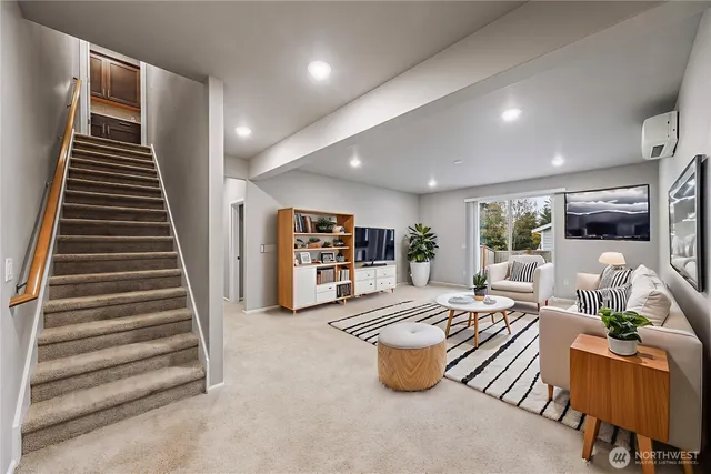 a living room with furniture and a kitchen