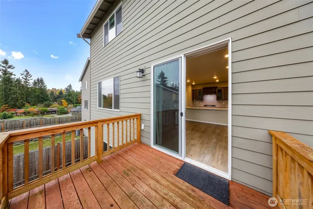 a view of a balcony with wooden floor and fence