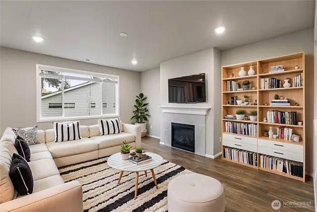 a living room with furniture a fireplace and a flat screen tv