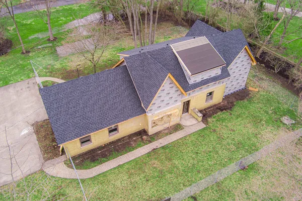 an aerial view of a house with a yard