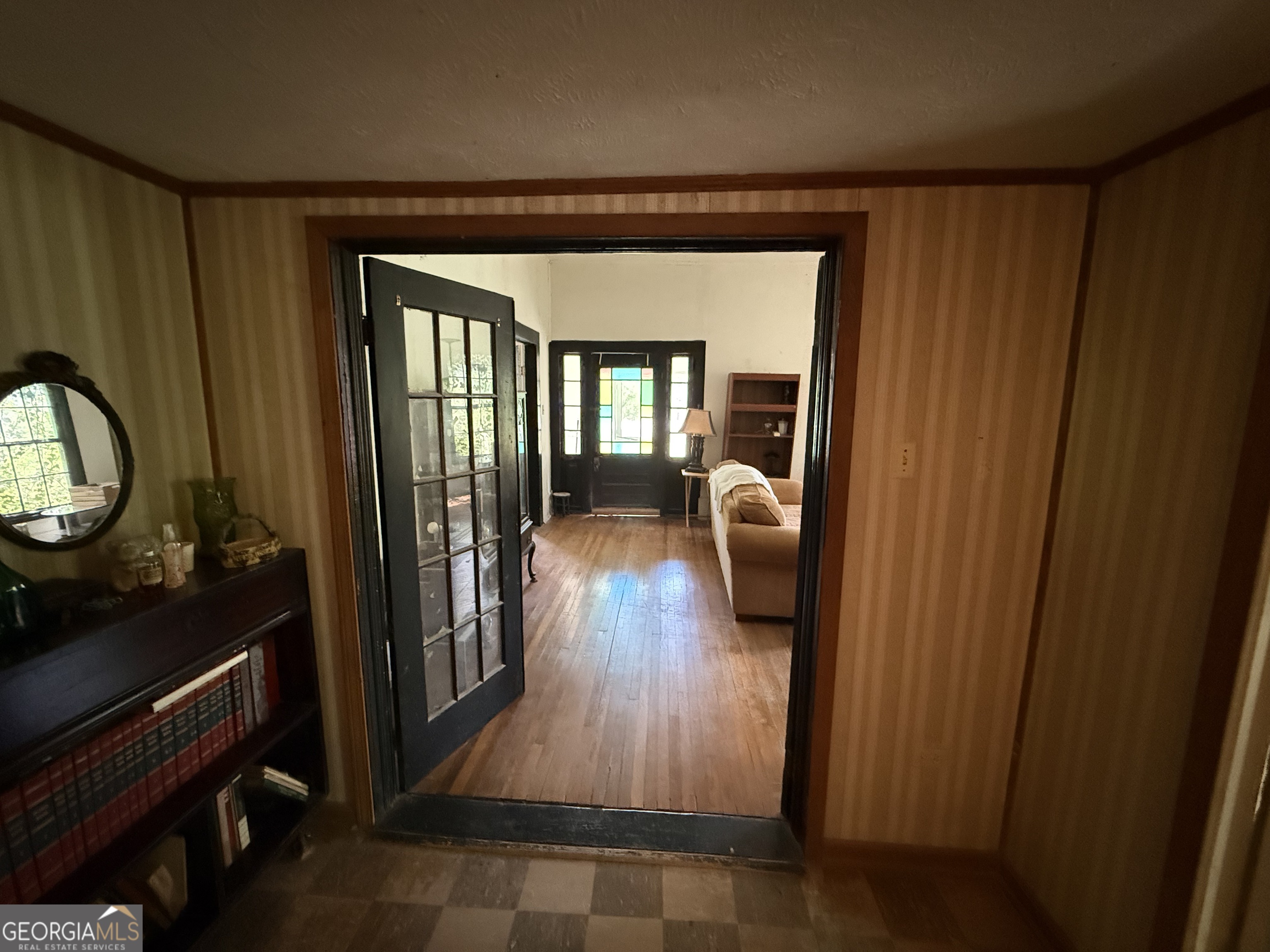 610 East Johnson Street Temple, GA 30179 - Photo 6 of 20 a hallway with wooden floor windows a fireplace and cabinet
