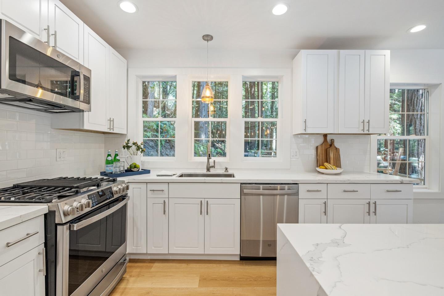 3945 Tunitas Creek Road Half Moon Bay, CA 94019 - Photo 54 of 64 a kitchen with stainless steel appliances granite countertop a stove a sink dishwasher and a microwave oven with wooden cabinets