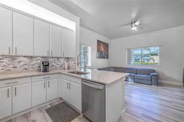 a kitchen with a sink cabinets and wooden floor