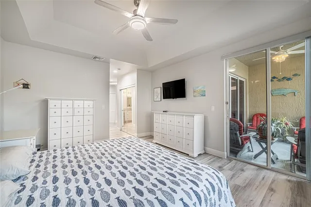 a bedroom with a bed and a flat tv screen