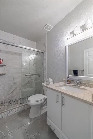 a view of swimming pool with a lounge chairs in a patio