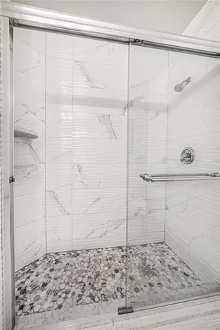 a living room filled with furniture and a floor to ceiling window