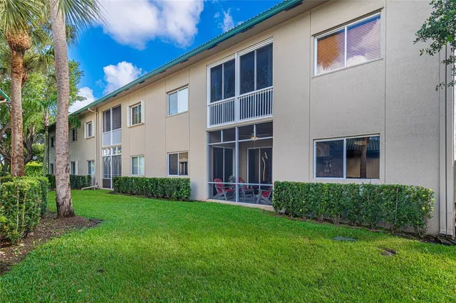 a view of a chairs and table in patio with a lake view