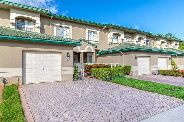 a front view of a house with a yard and a garage