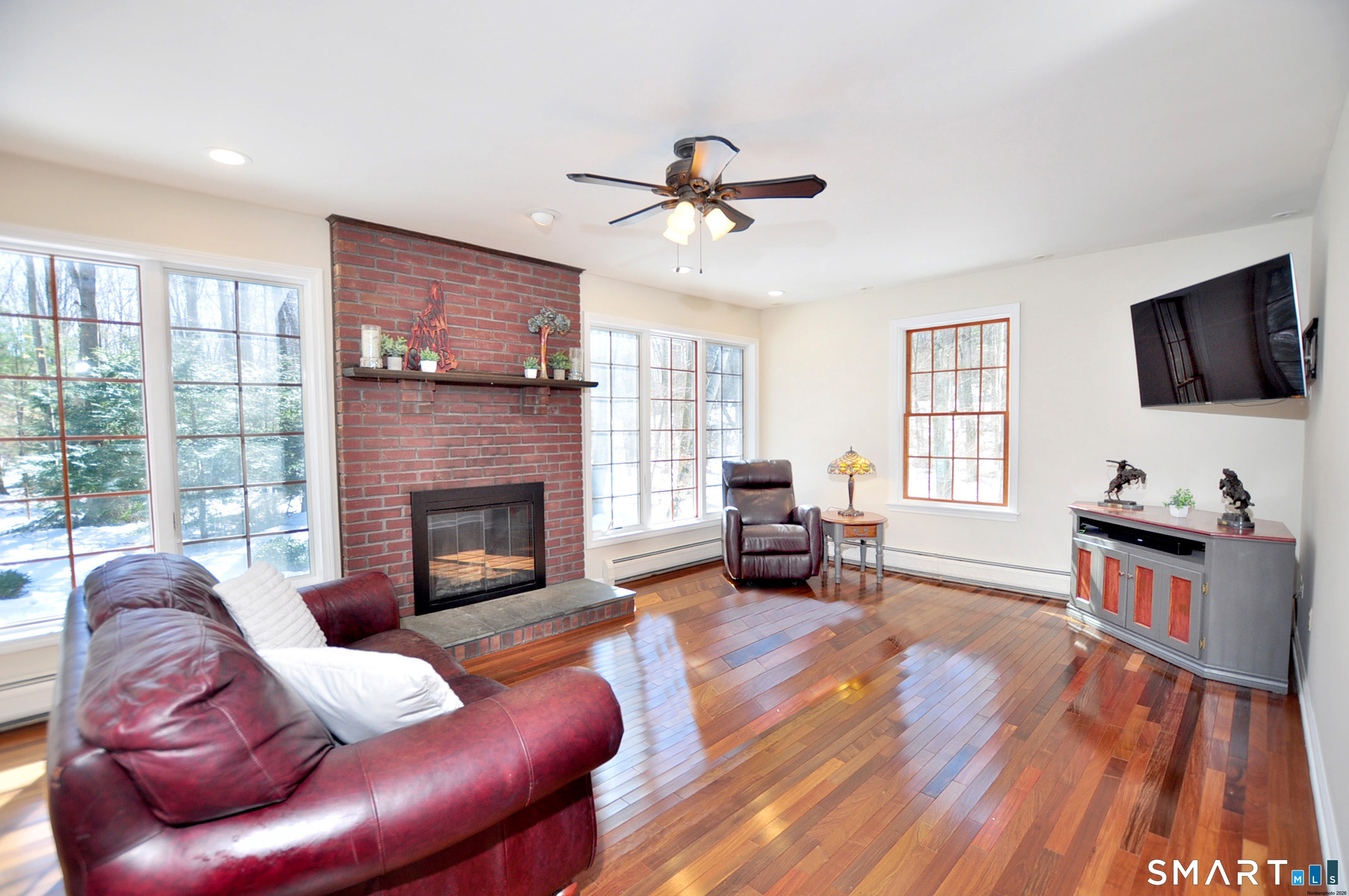 102 Petersen Road Granby, CT 06035 - Photo 11 of 40 a living room with furniture a fireplace and a flat screen tv