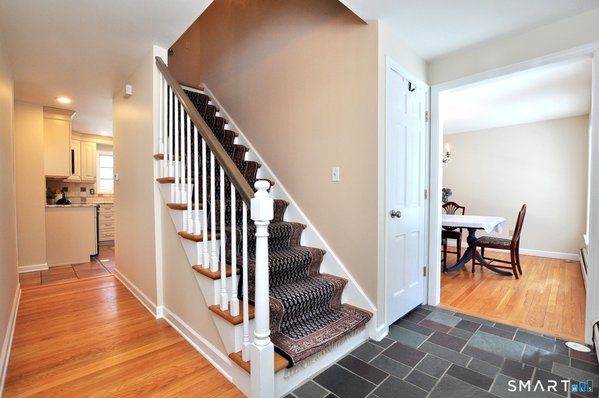 102 Petersen Road Granby, CT 06035 - Photo 17 of 40 a view of a hallway with wooden floor and furniture