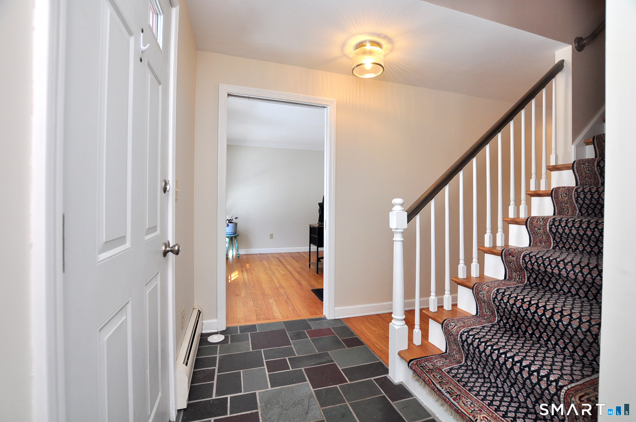 102 Petersen Road Granby, CT 06035 - Photo 18 of 40 a view of a hallway view with wooden floor and a bathroom
