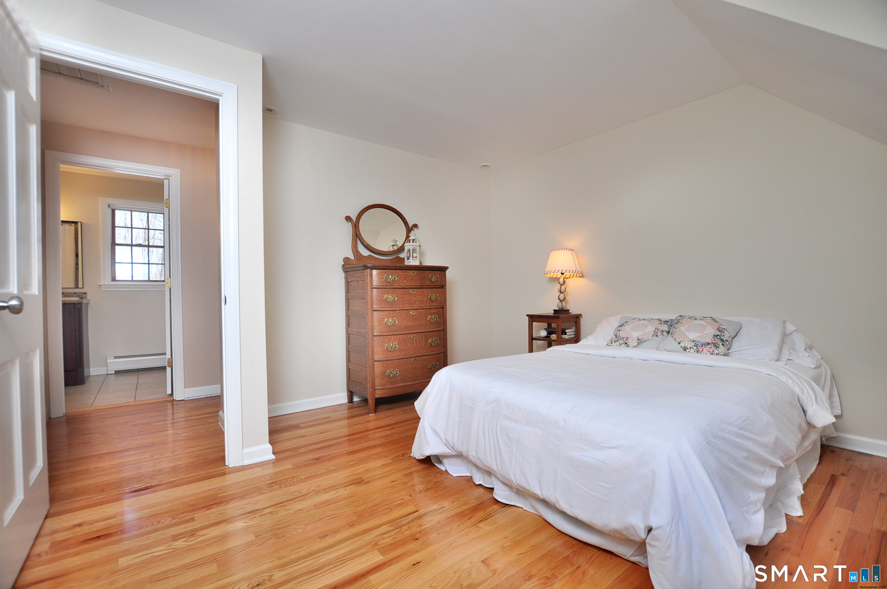 102 Petersen Road Granby, CT 06035 - Photo 25 of 40 a bedroom with a bed and wooden floor