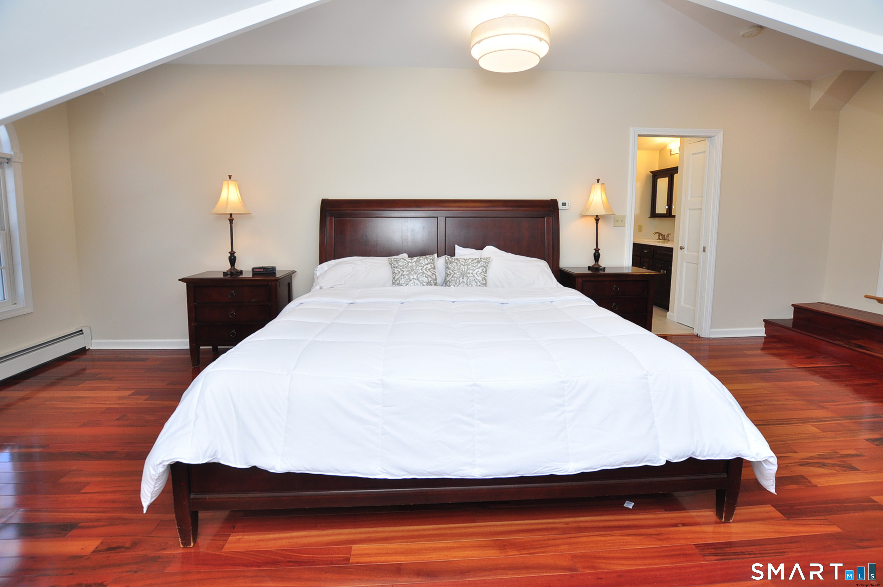 102 Petersen Road Granby, CT 06035 - Photo 32 of 40 a bedroom with a bed and wooden floor