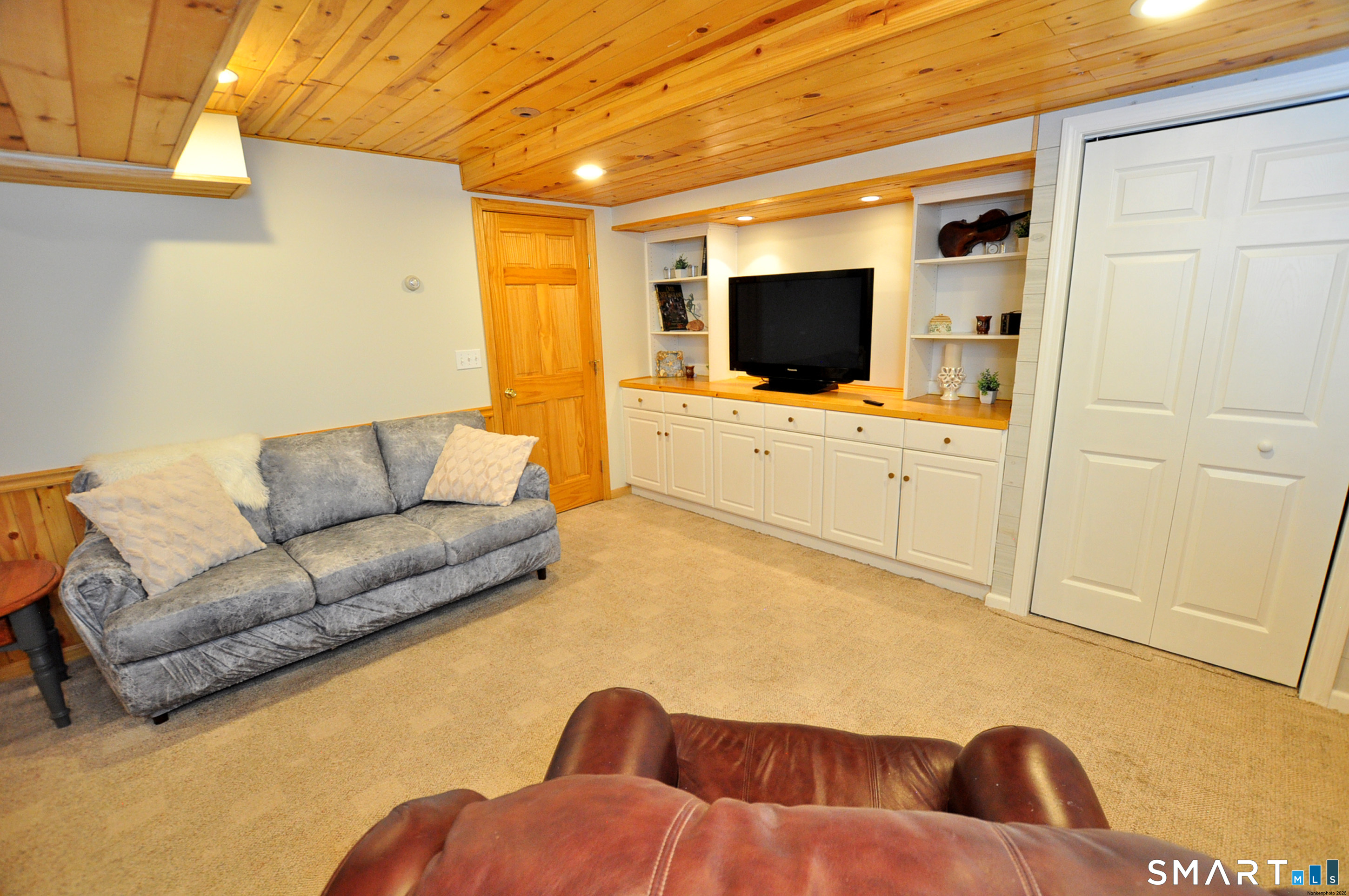 102 Petersen Road Granby, CT 06035 - Photo 35 of 40 a living room with furniture and a flat screen tv