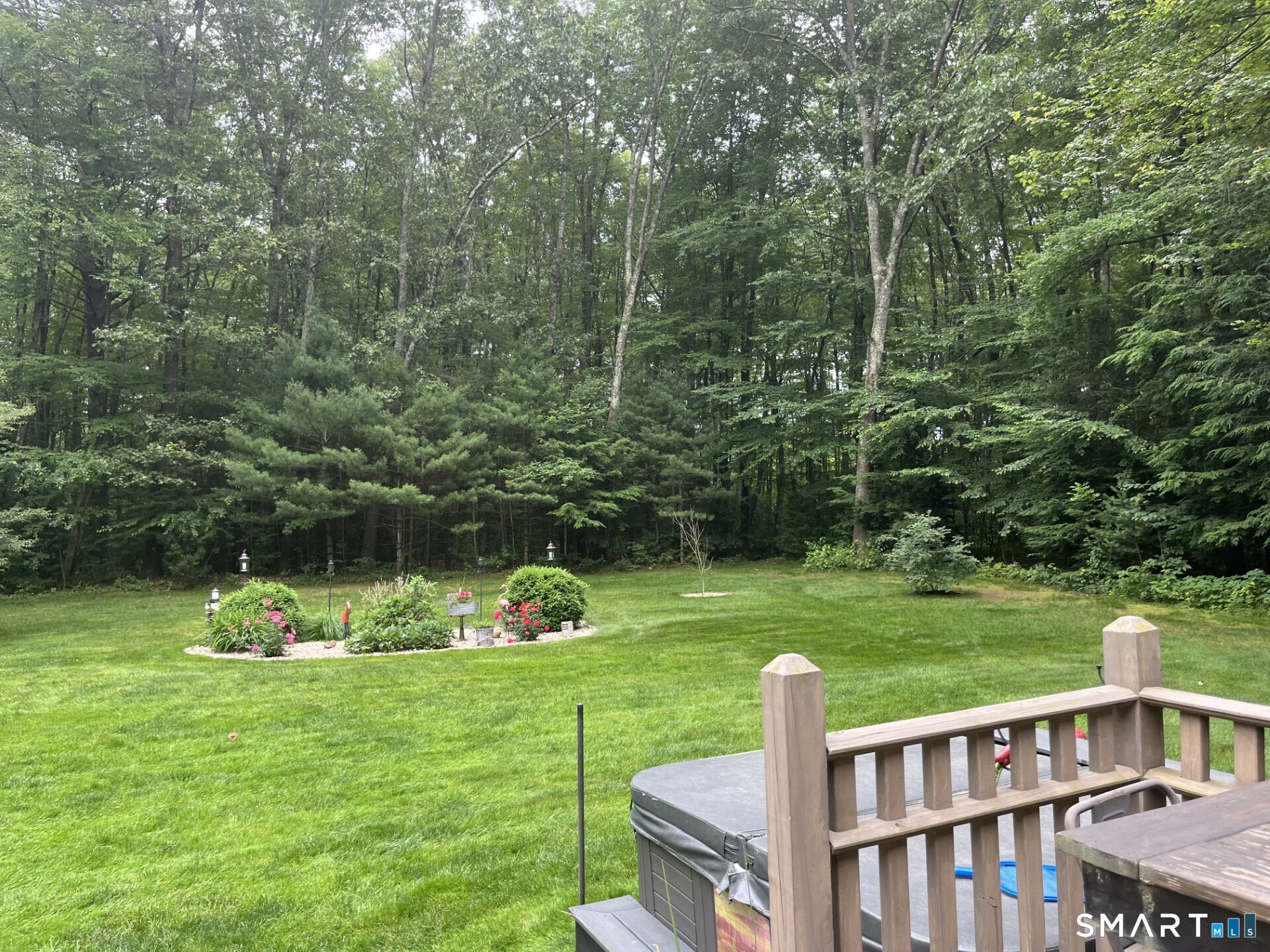 102 Petersen Road Granby, CT 06035 - Photo 36 of 40 a view of a wooden deck and a garden