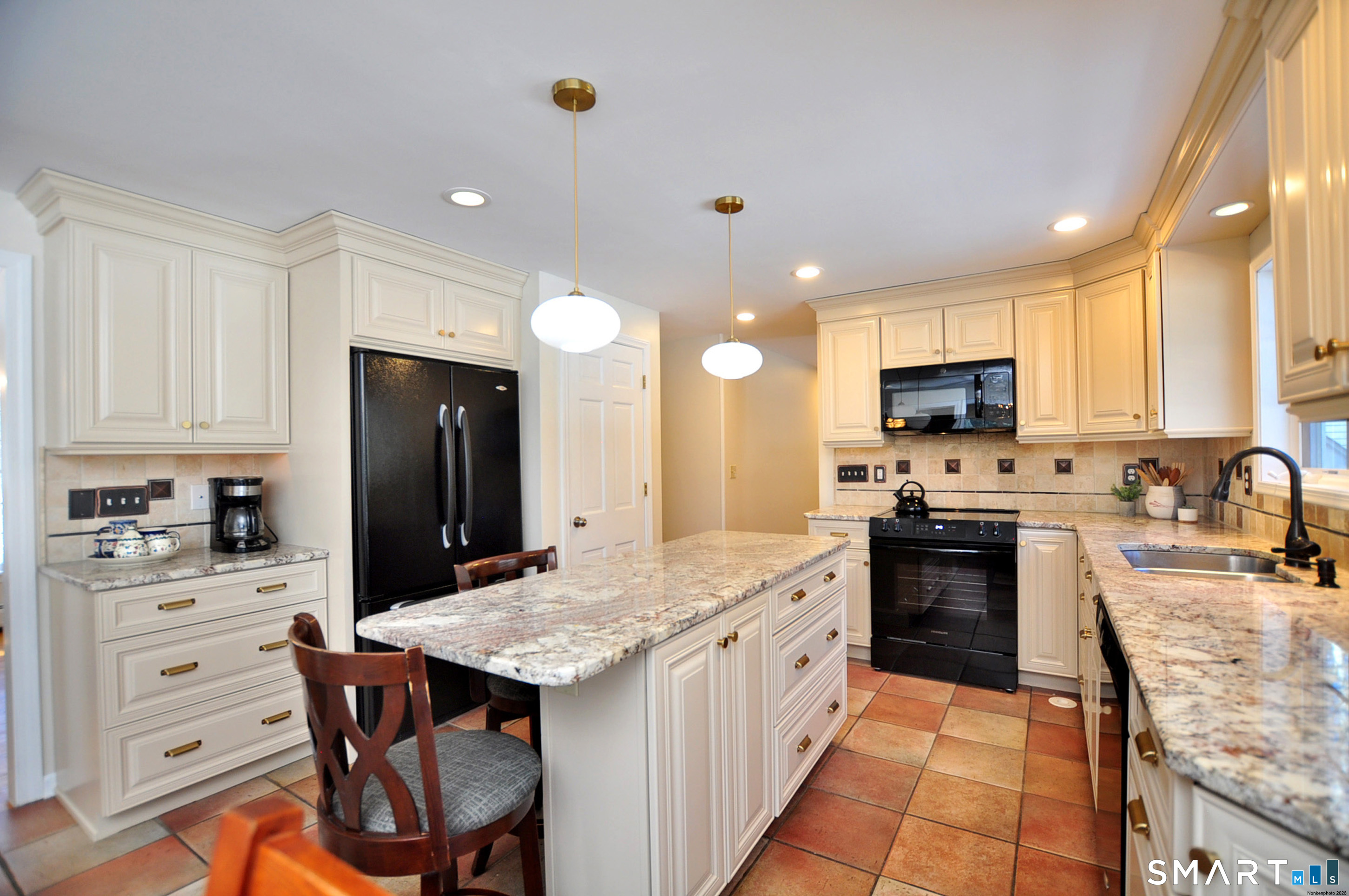 102 Petersen Road Granby, CT 06035 - Photo 5 of 40 a kitchen with stainless steel appliances kitchen island granite countertop a refrigerator stove microwave and sink