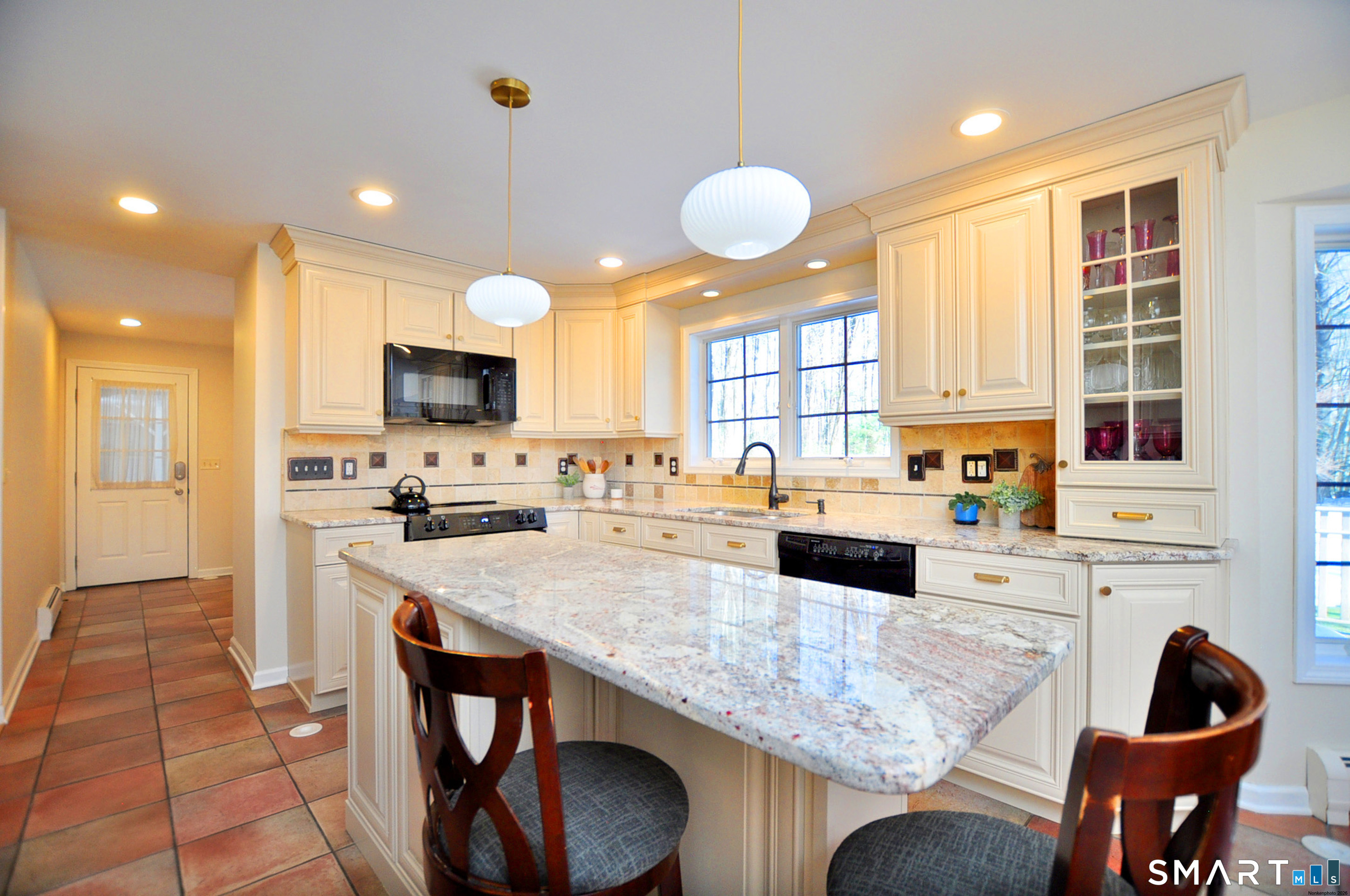 102 Petersen Road Granby, CT 06035 - Photo 7 of 40 a kitchen with granite countertop white cabinets and stainless steel appliances