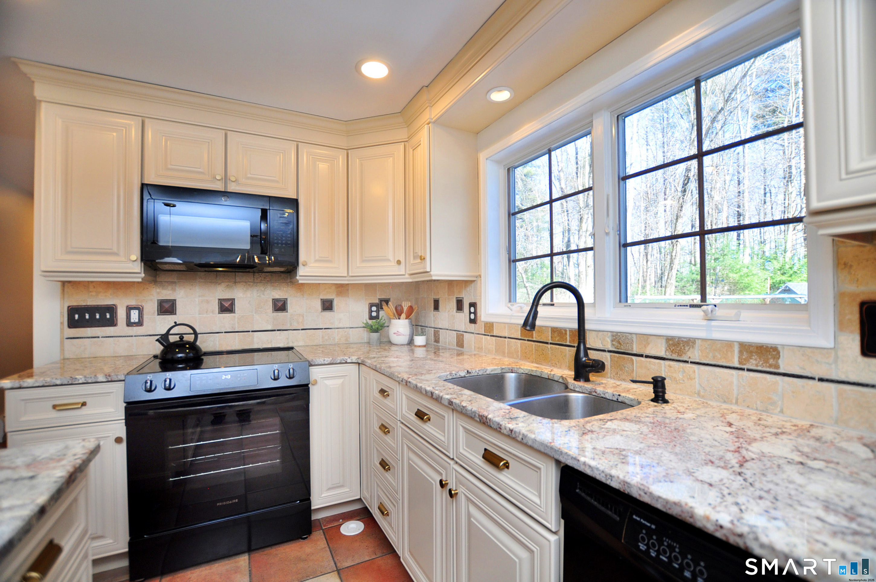 102 Petersen Road Granby, CT 06035 - Photo 8 of 40 a kitchen with stainless steel appliances granite countertop a stove and a sink