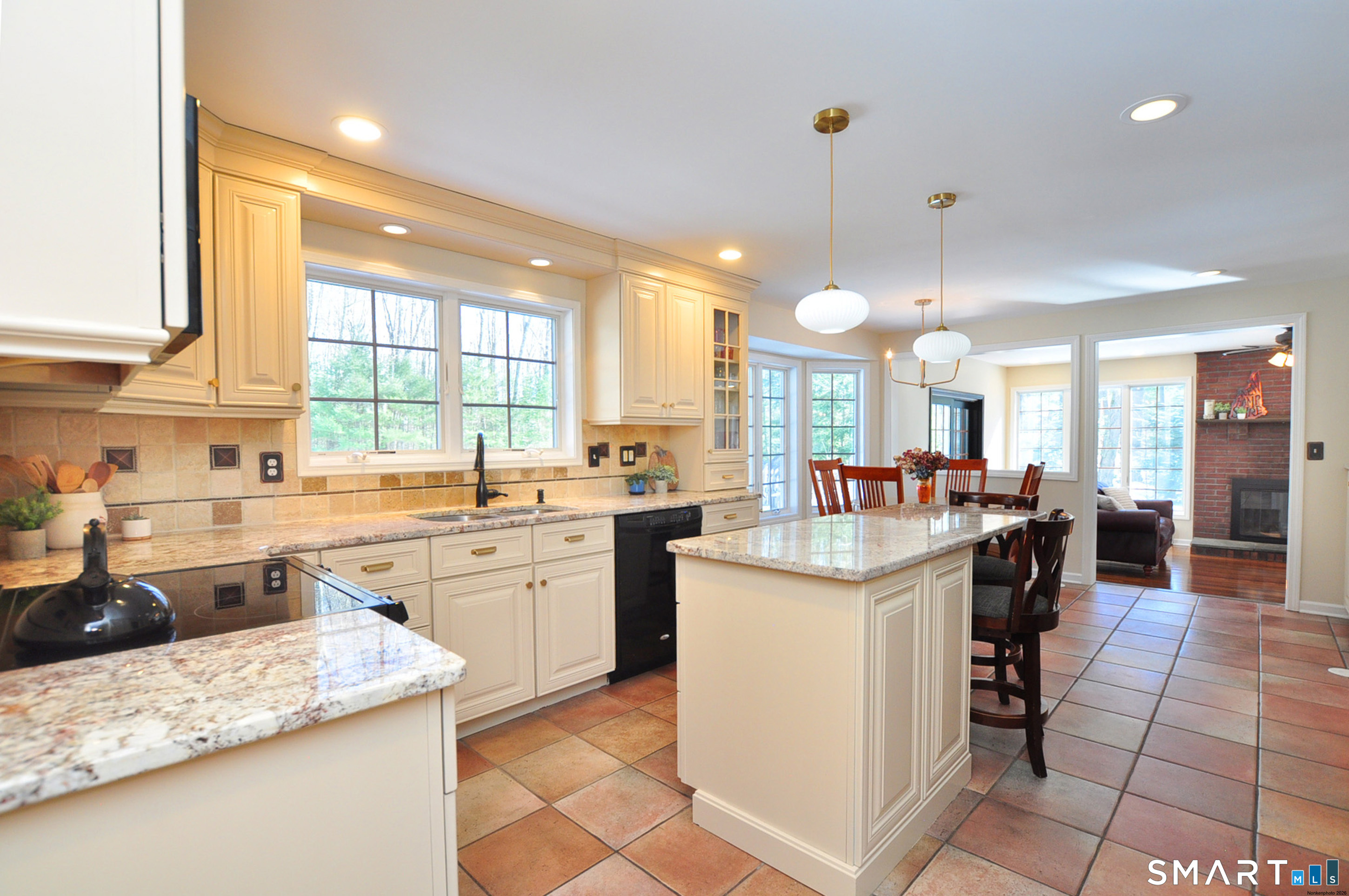 102 Petersen Road Granby, CT 06035 - Photo 9 of 40 a kitchen with a sink a counter top space appliances and a window