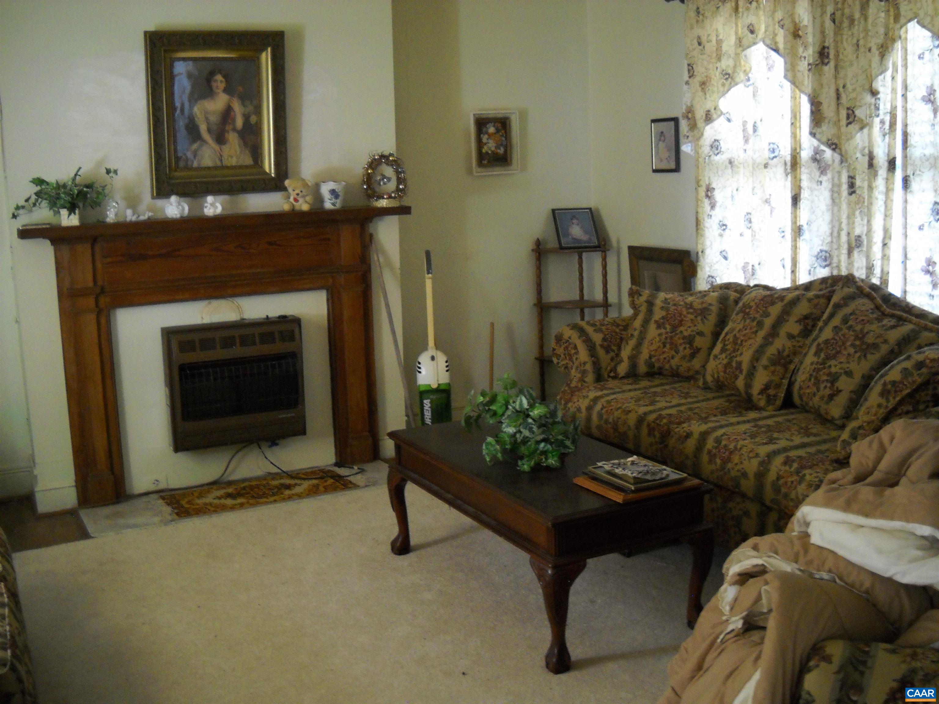 342 Morgans Hill Road Arvonia, VA 23004 - Photo 4 of 5 a living room with furniture and a fireplace
