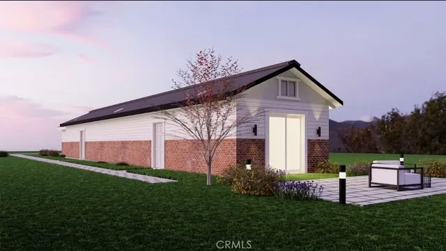 a front view of a house with a yard and outdoor seating