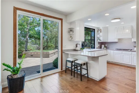 a kitchen with a sink cabinets and window
