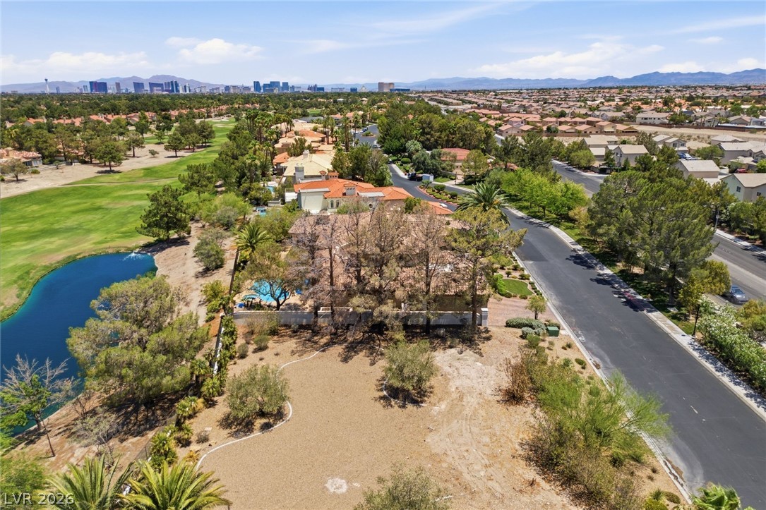 20 Innisbrook Avenue Las Vegas, NV 89113 - Photo 3 of 39 An aerial perspective reveals a luxurious home alongside a verdant golf course and serene water feature.
