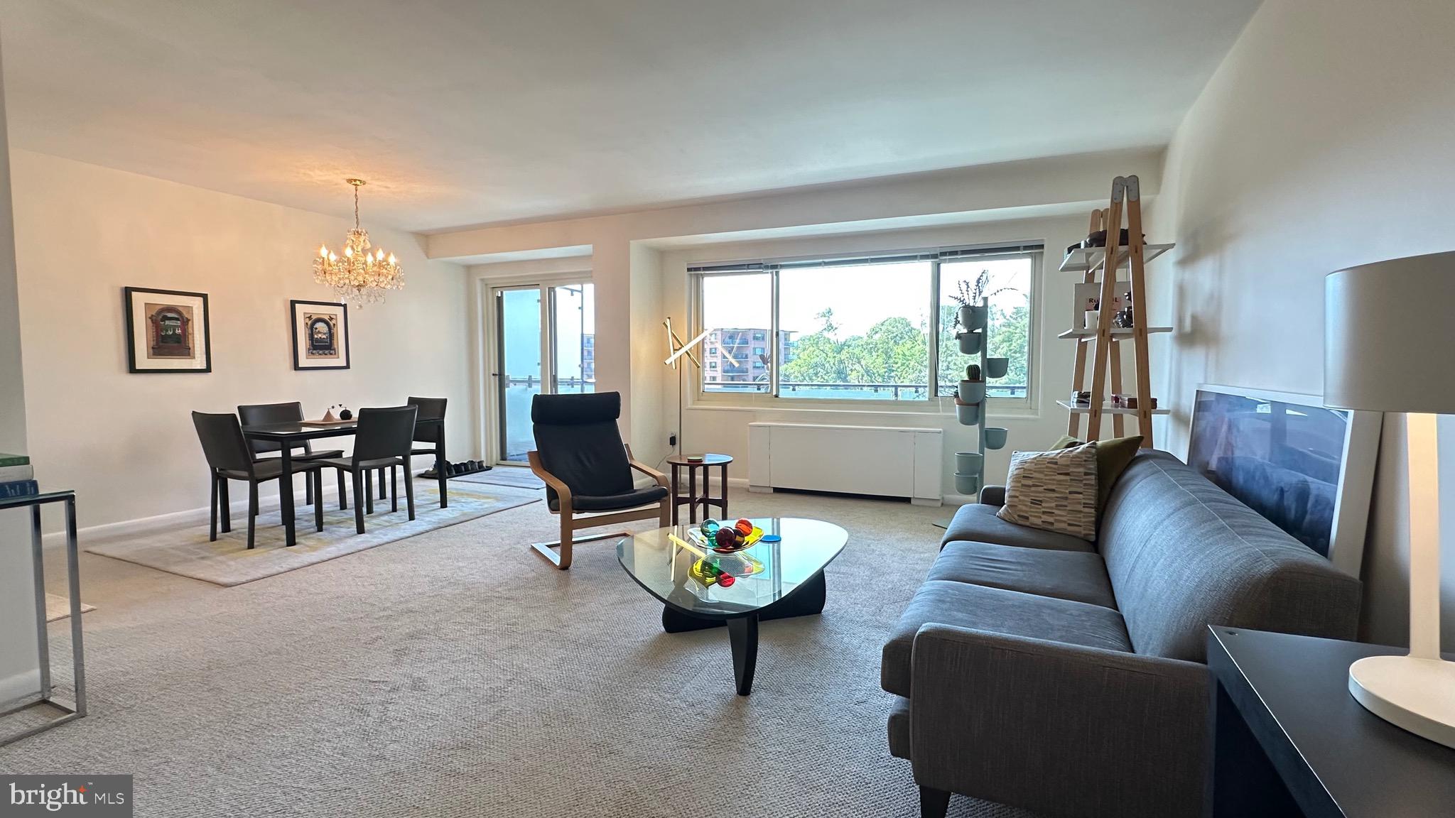 4201 Cathedral Avenue Northwest, Unit 1121E Washington, DC 20016 - Photo 11 of 25 a living room with furniture and a large window