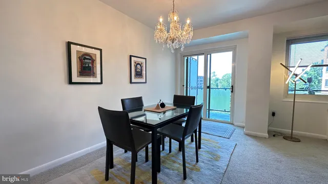 a view of a dining room with furniture and chandelier