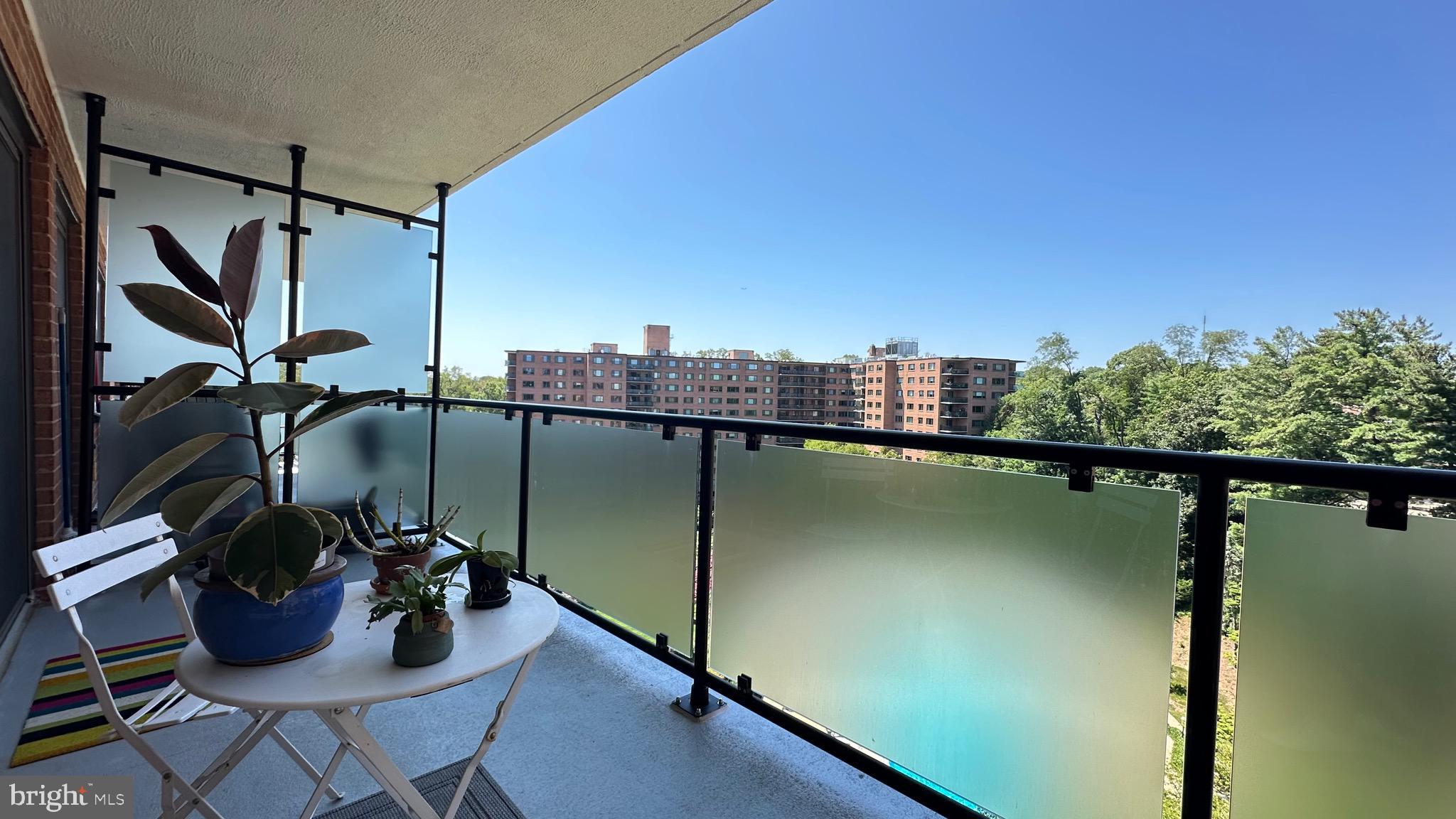4201 Cathedral Avenue Northwest, Unit 1121E Washington, DC 20016 - Photo 20 of 25 a view of a balcony with chair and potted plants