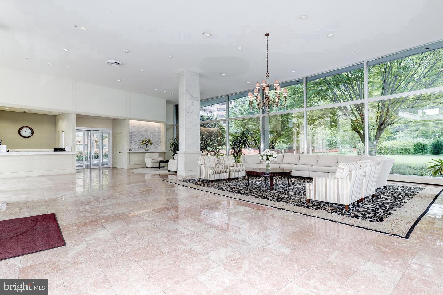 4201 Cathedral Avenue Northwest, Unit 1121E Washington, DC 20016 - Photo 3 of 25 a living room with couch and a table