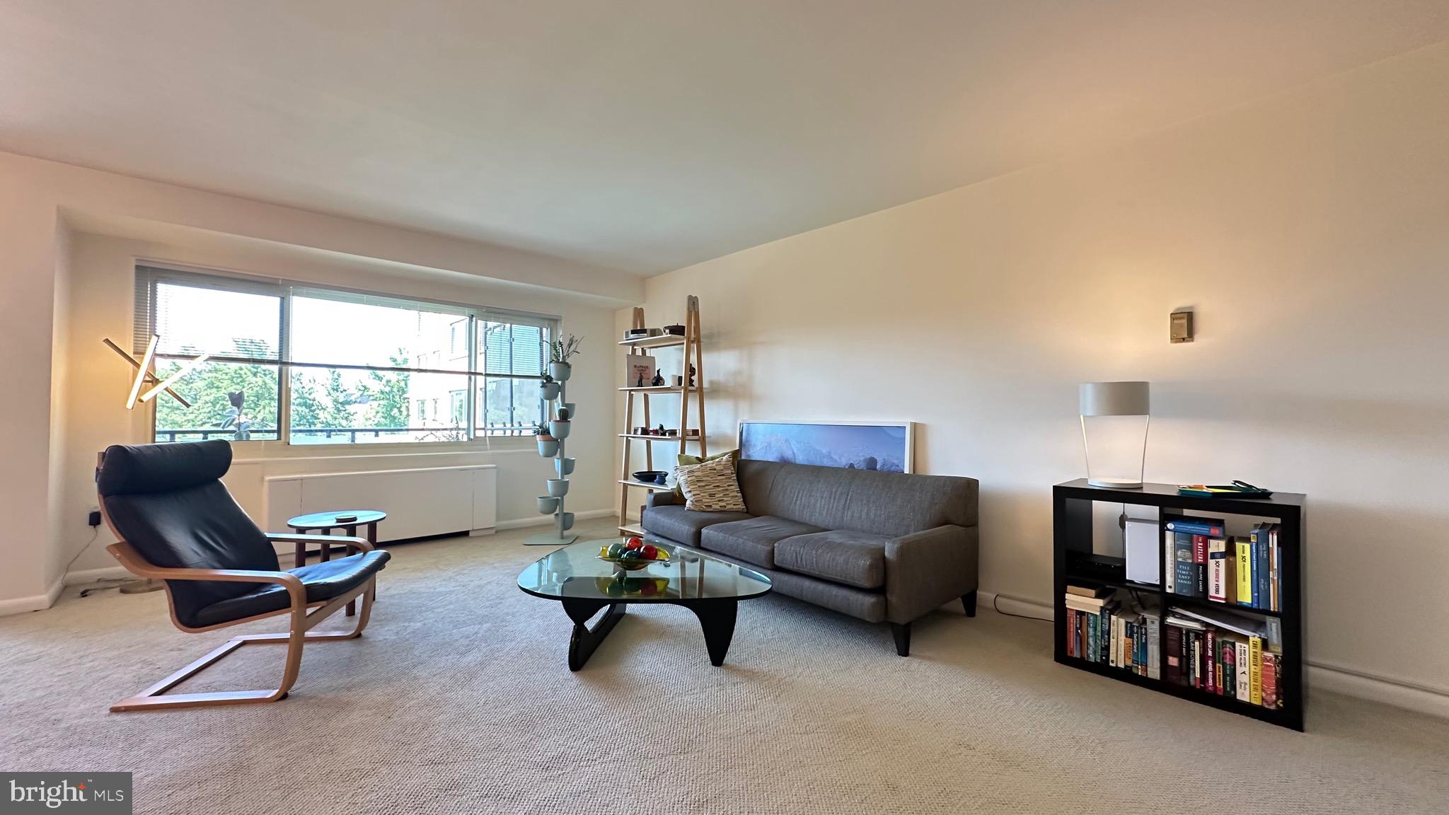4201 Cathedral Avenue Northwest, Unit 1121E Washington, DC 20016 - Photo 6 of 25 a living room with furniture and a window