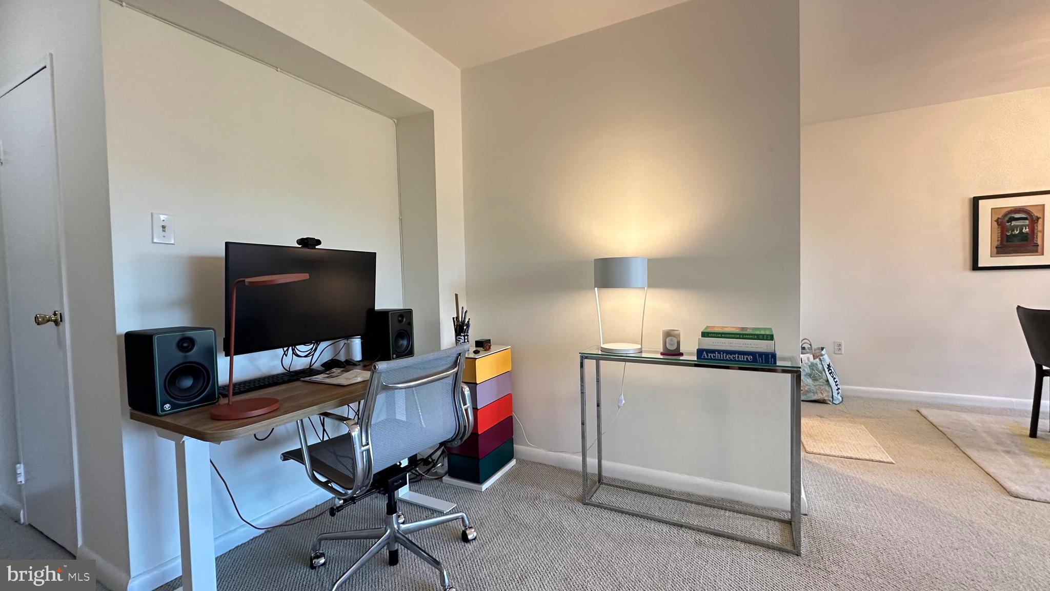 4201 Cathedral Avenue Northwest, Unit 1121E Washington, DC 20016 - Photo 8 of 25 a view of a workspace with furniture and a window