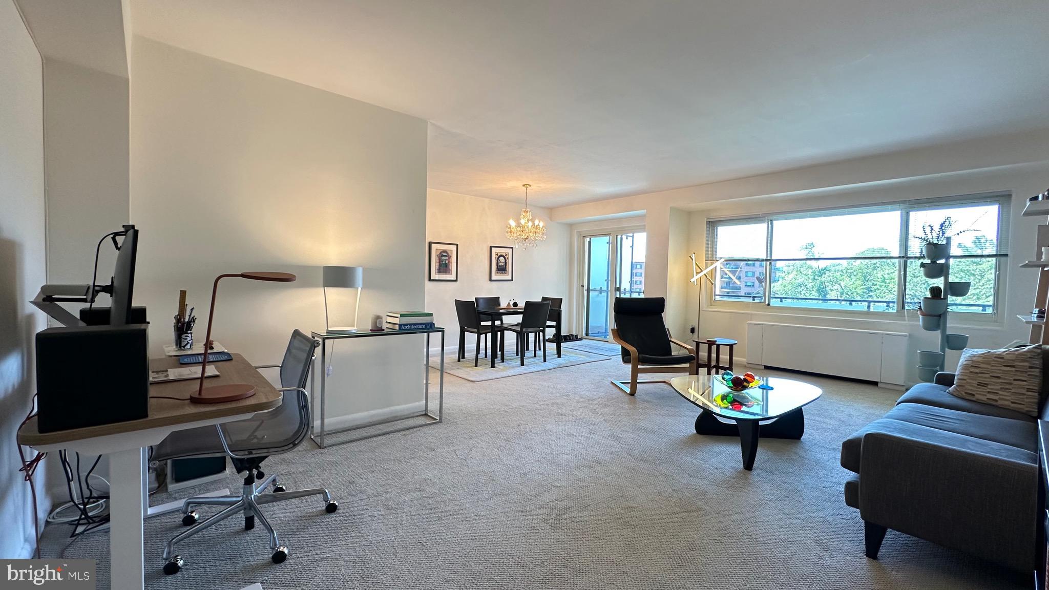 4201 Cathedral Avenue Northwest, Unit 1121E Washington, DC 20016 - Photo 9 of 25 a living room with furniture and a window