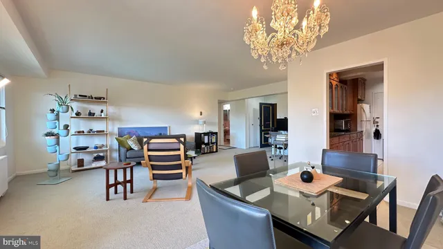 a view of a dining room with furniture and a chandelier
