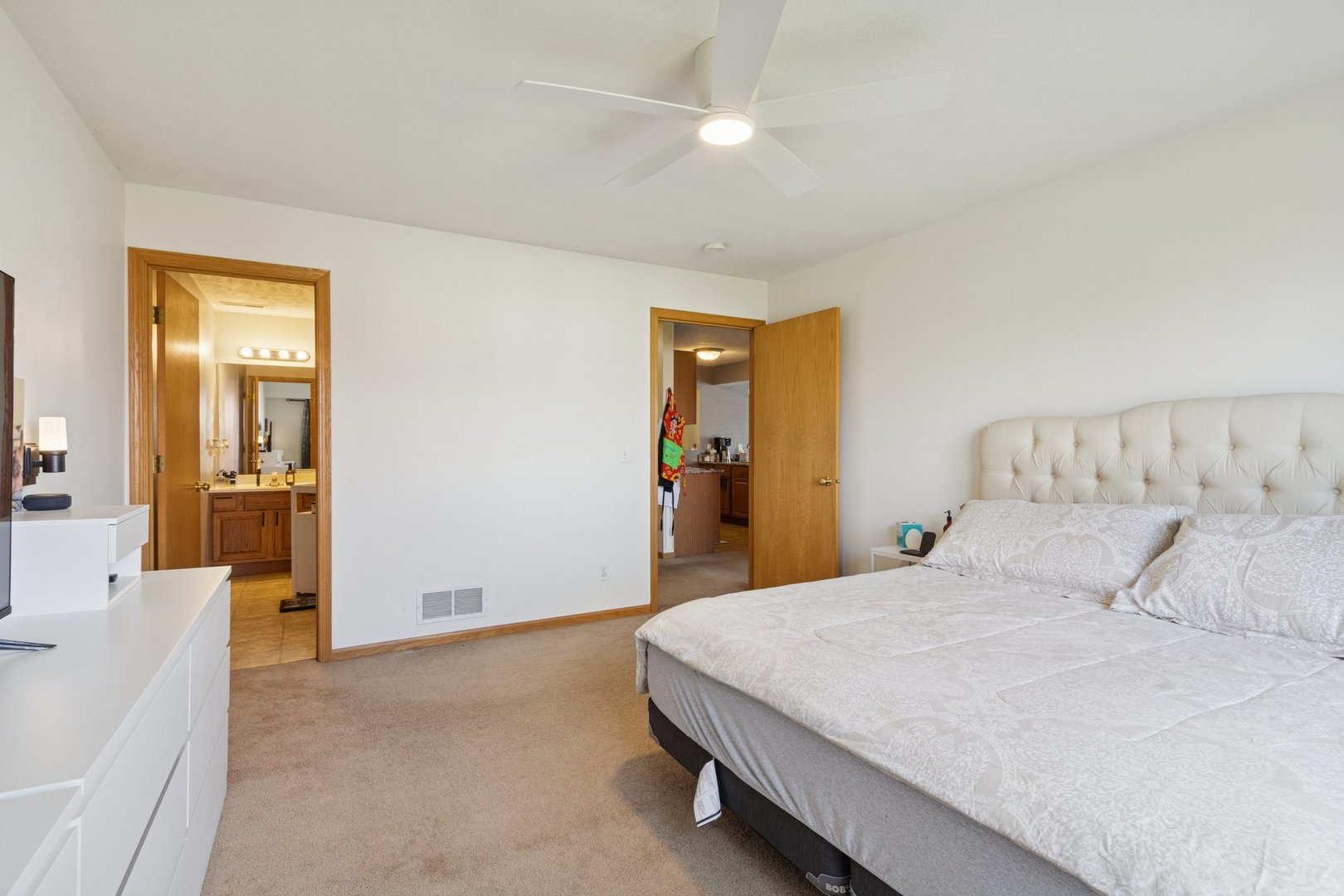 145 Penny Lane, Unit 1 Sycamore, IL 60178 - Photo 22 of 30 a bedroom with a bed and a chandelier