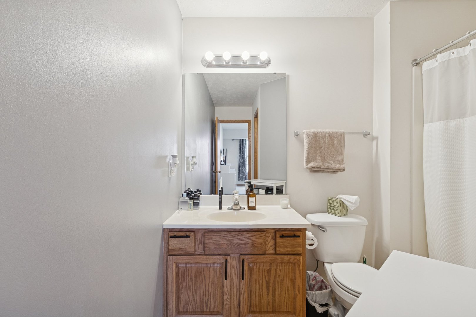 145 Penny Lane, Unit 1 Sycamore, IL 60178 - Photo 23 of 30 a bathroom with a sink and a mirror with toilet