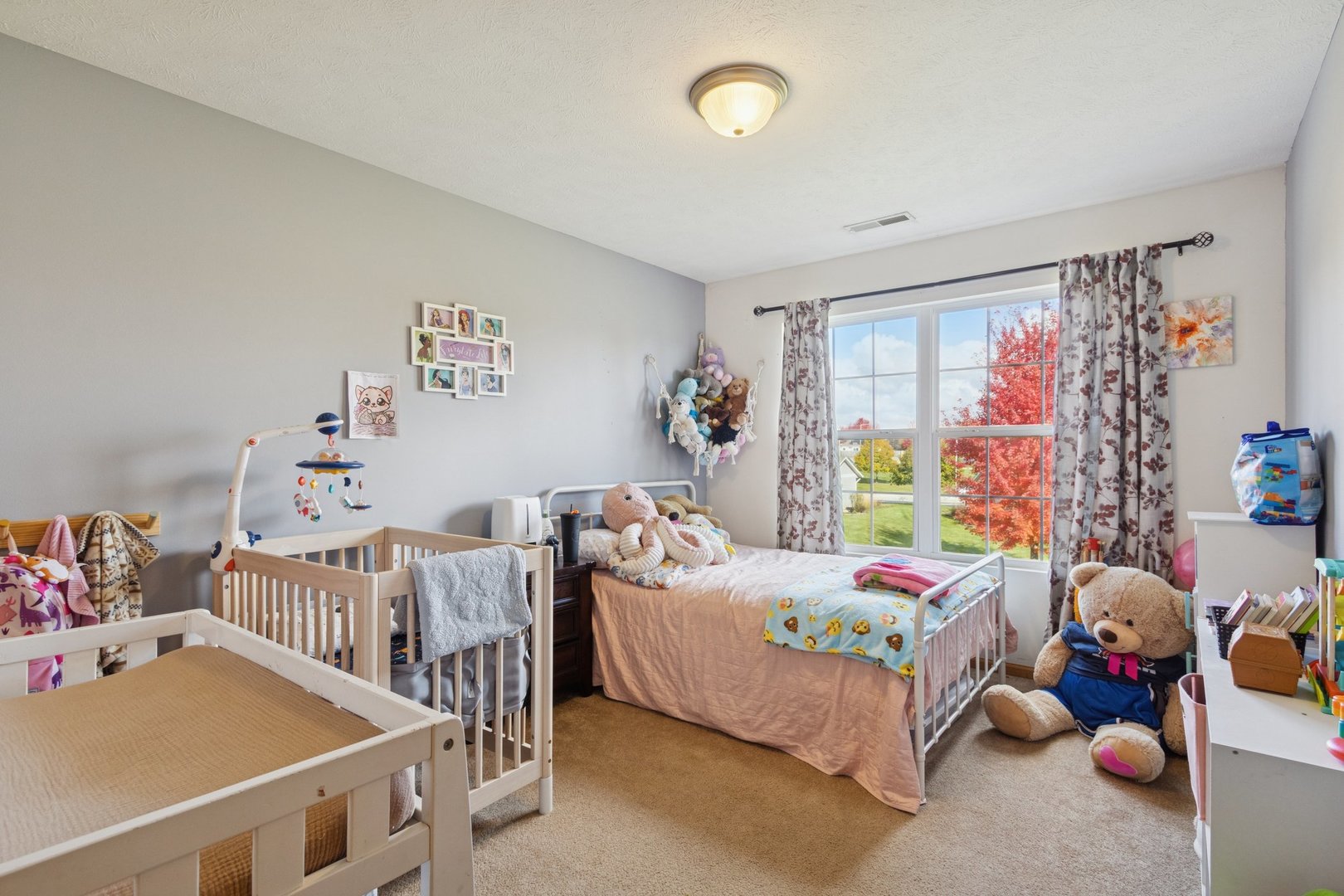 145 Penny Lane, Unit 1 Sycamore, IL 60178 - Photo 24 of 30 a bedroom with a bed and a baby crib