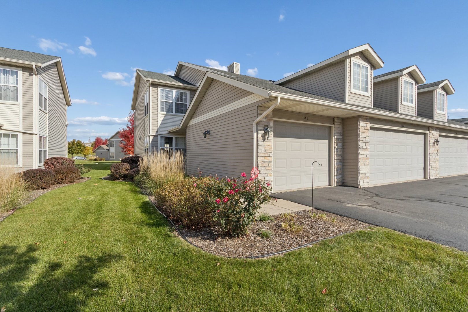 145 Penny Lane, Unit 1 Sycamore, IL 60178 - Photo 30 of 30 a front view of a house with garden