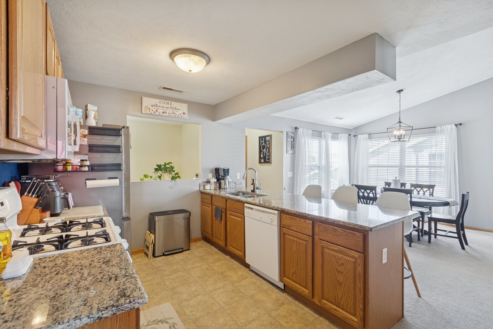 145 Penny Lane, Unit 1 Sycamore, IL 60178 - Photo 7 of 30 a large kitchen with stainless steel appliances granite countertop a sink stove and refrigerator