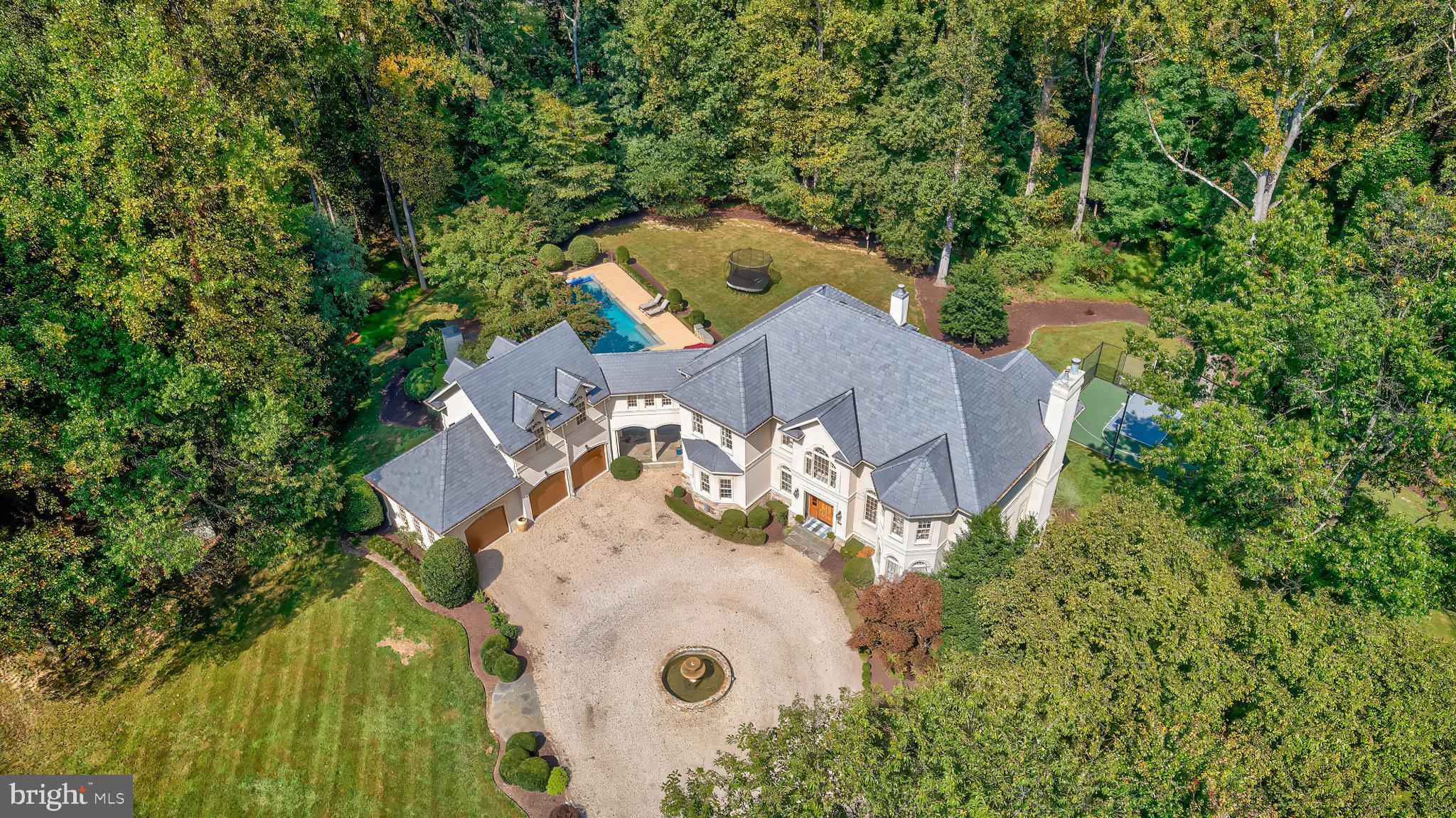 an aerial view of a house with yard swimming pool and outdoor seating